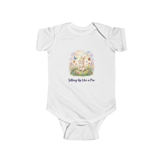 White baby onesie with a printed design of a bunny and text on a white background